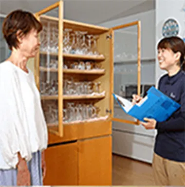 グラス棚の前で相談する女性とスタッフ